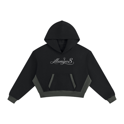 A black cropped hoodie with dark gray contrast panels on the front pocket and hem, featuring a small gray wing logo on the chest, displayed on a solid white background.