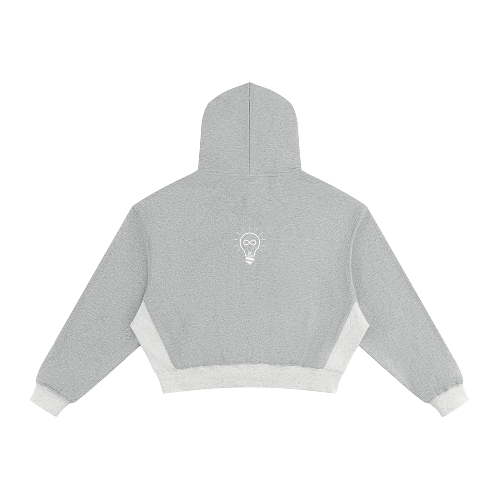 A light gray cropped hoodie shown from the back, featuring contrasting white knit panels at the bottom and cuffs, displayed on a solid white background.