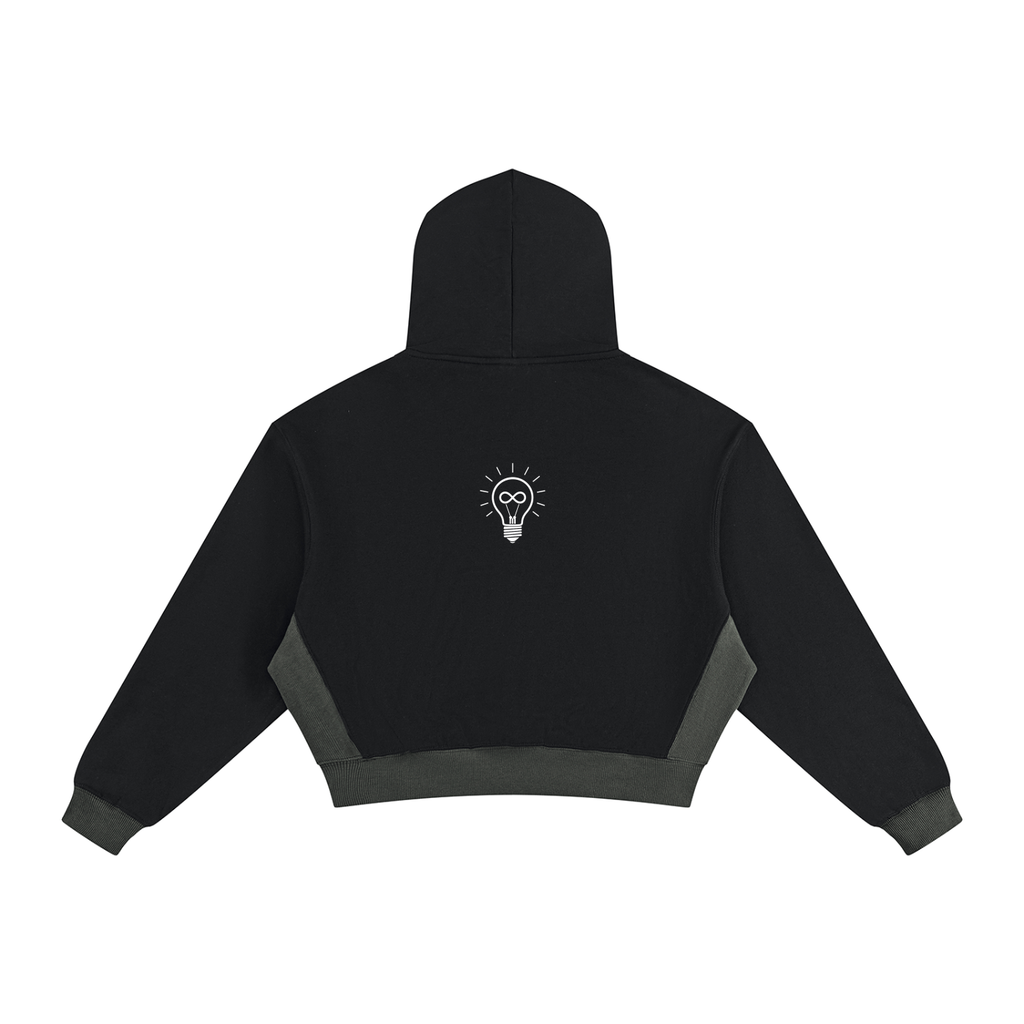 Black cropped hoodie with dark gray contrast panels on the sides and cuffs, featuring a small 'RISE LUXE' logo printed on the back center, shown against a plain white background.